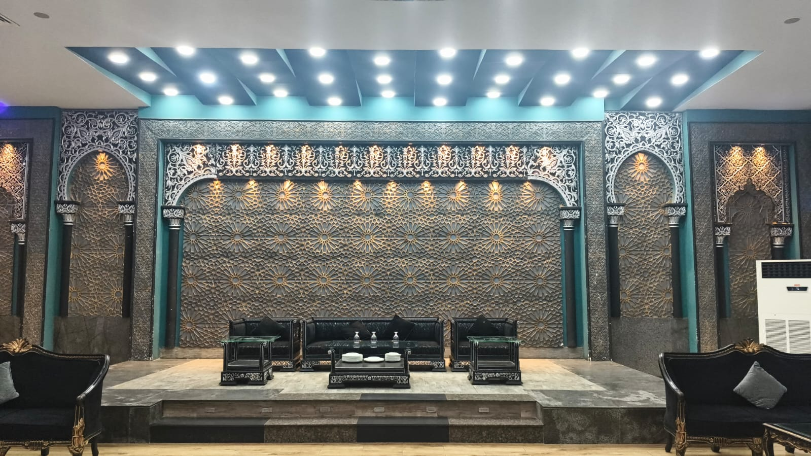 Ornate stage wall and dark seating at Grand Castle