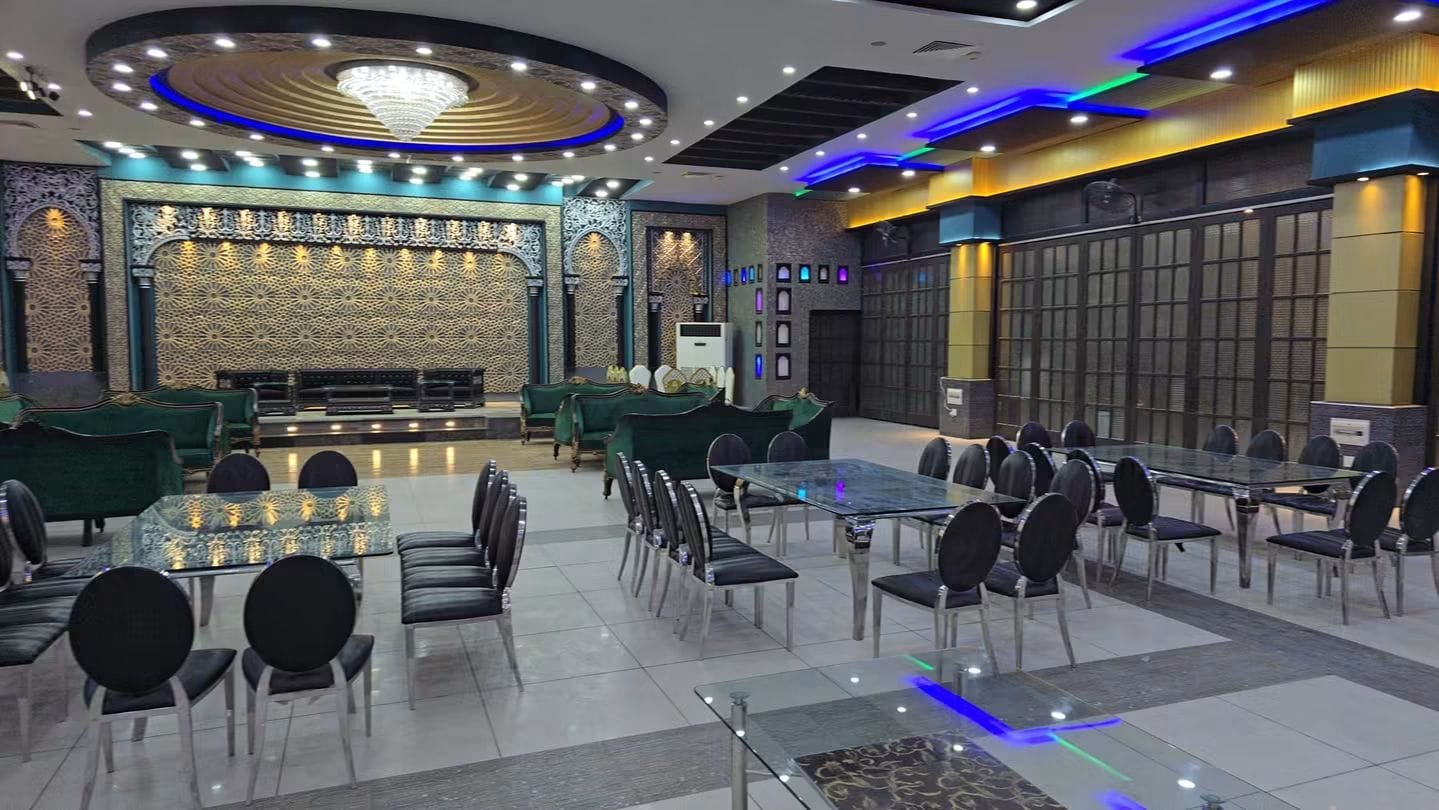 Wide view of Grand Castle Event Complex showing teal seating, decorative walls and ceiling lights